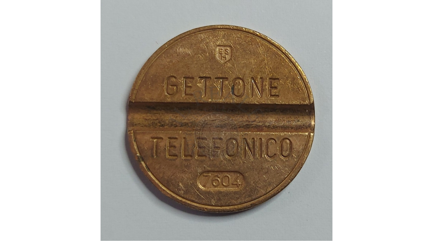 GETTONE TELEFONICO CON SEGNO DI ZECCA NUMERO DI SERIE 7604 RARO